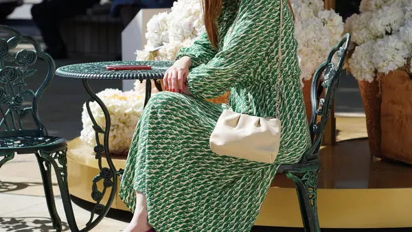 young women with neutral hand bag